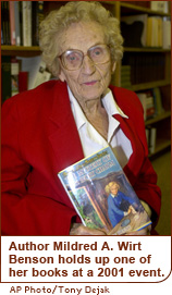 Author Mildred A. Wirt Benson holds up one of her books at a 2001 event.