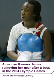 American Kamara James removes her gear after a bout in the 2004 Olympic Games