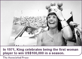 In 1971, King celebrates being the first woman player to win US$100,000 in a season.