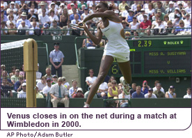 Venus closes in on the net during a match at Wimbledon in 2000.