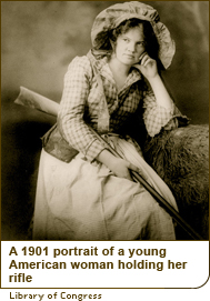 A 1901 portrait of a young American woman holding her rifle