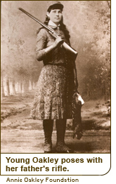 Young Oakley poses with her father’s rifle.